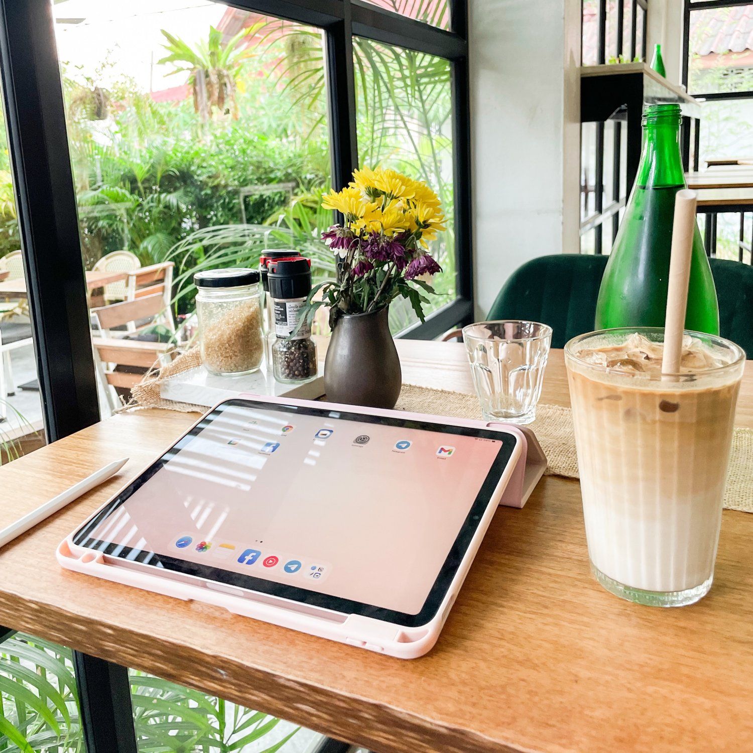 iPad at a cafe with iced coffee, perfect note-taking device for digital nomads